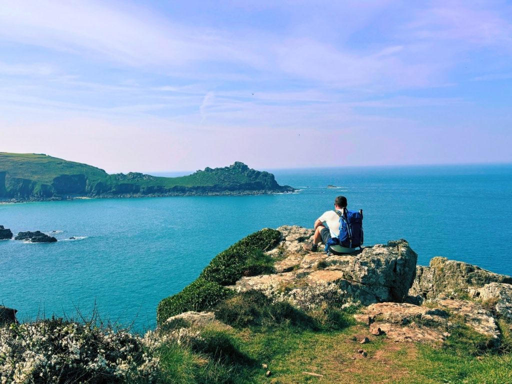 Projects at Bimbling, Books & Beer featuring Dan on the South West Coast Path overlooking the Cornish coastline during an outdoor walking adventure.