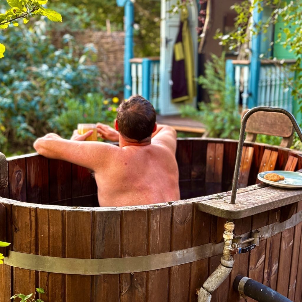 Stays and experience content showing a relaxed hot tub moment at Free Range Escapes Cornwall captured by Bimbling Books and Beer