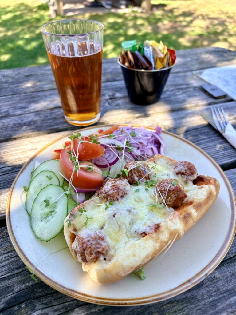 A meatball sub and a glass of Scilly Cider at Carn Vean Cafe